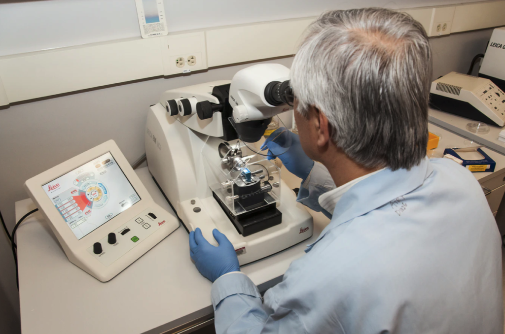 Man using a Clinical Compound Microscopes